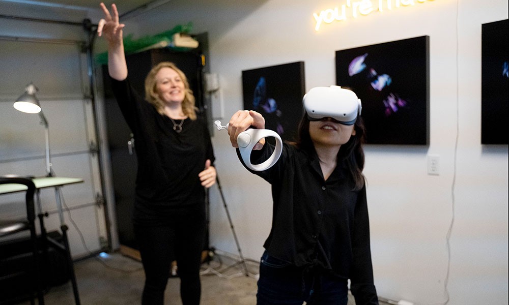 Megan Smith directing someone using a VR headset